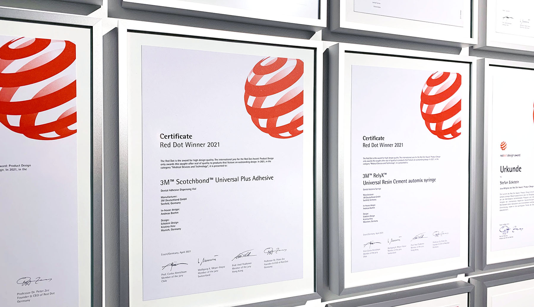 Photo of two red dot design wards for 3M hanging on a wall