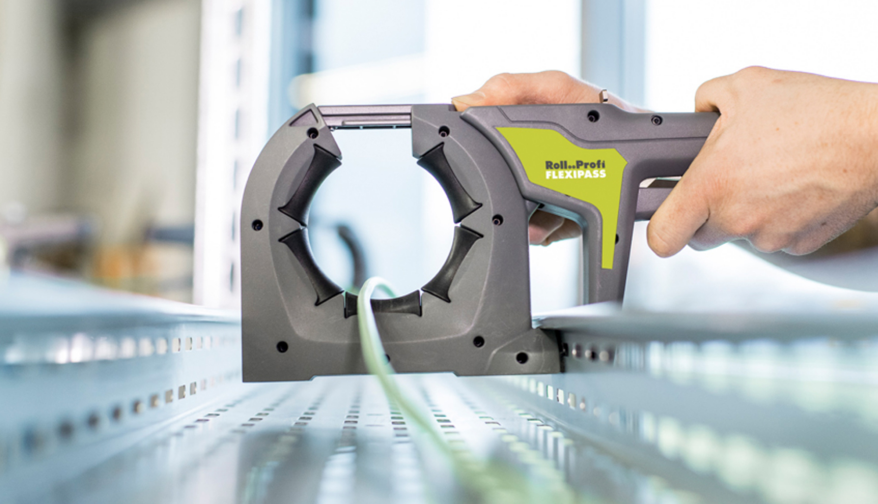 Rollprofi Flexipass is used to guide a cable through a cable trough showing the ease of use