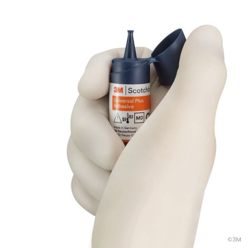Hand holding a 3M Scotchbond Bottle showing the patetned cap design