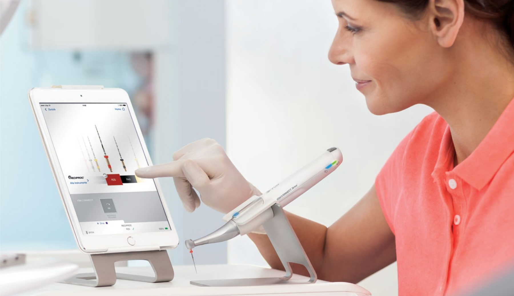 Dentist using the VDW app with the VDW Connect Endo motor in front