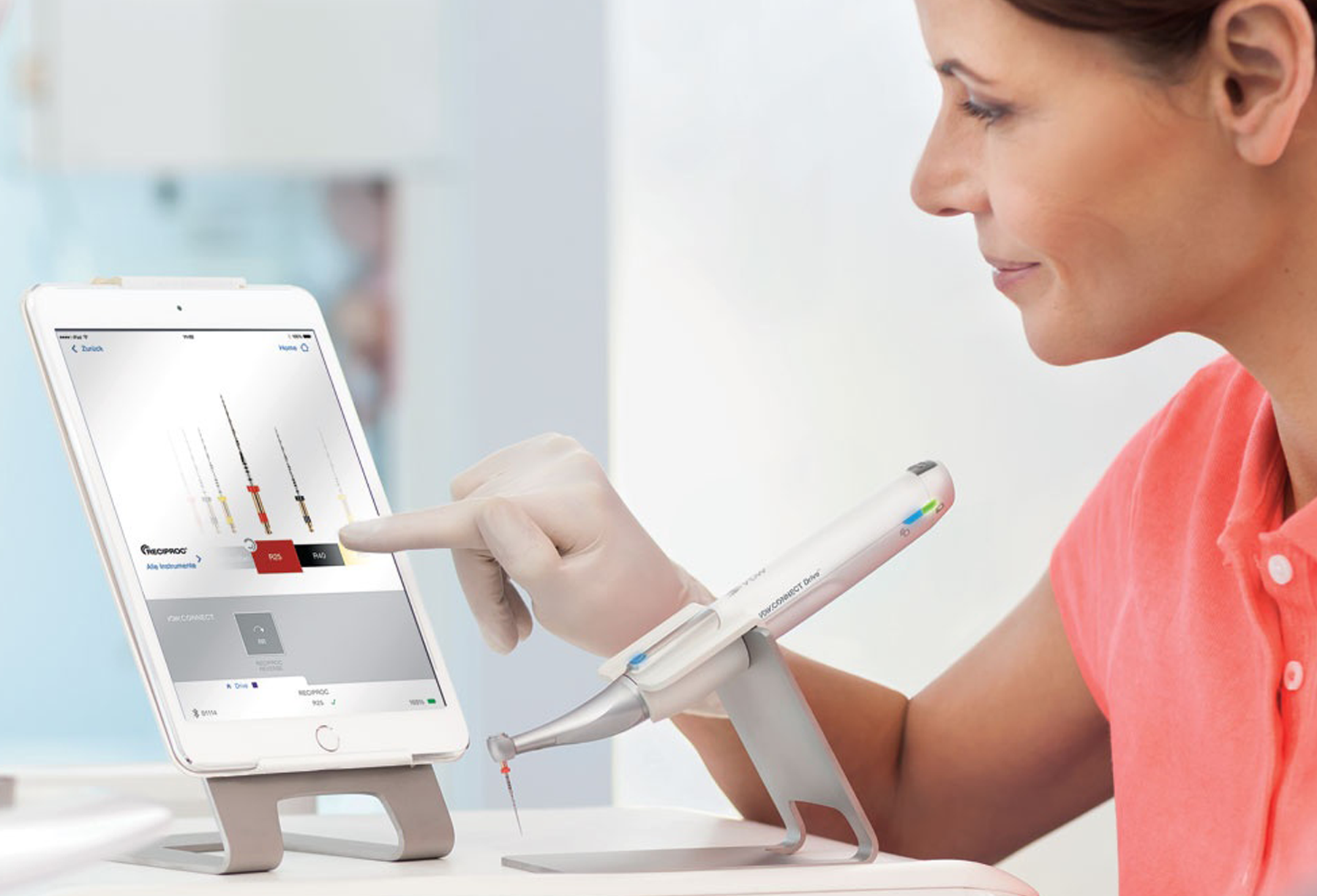 Dentist using the VDW app with the VDW Connect Endo motor in front
