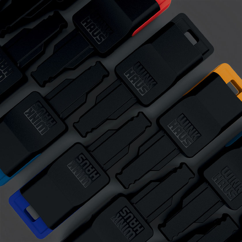 multiple winkhause blueEvo keys laying on black background with different colored caps showing the versatile industrial design